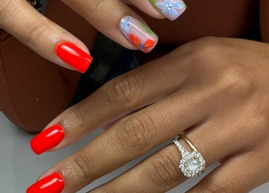 Floral and vibrant red nails at Chic Nail Studio, Arlington, Virginia, US, showcasing detailed design.