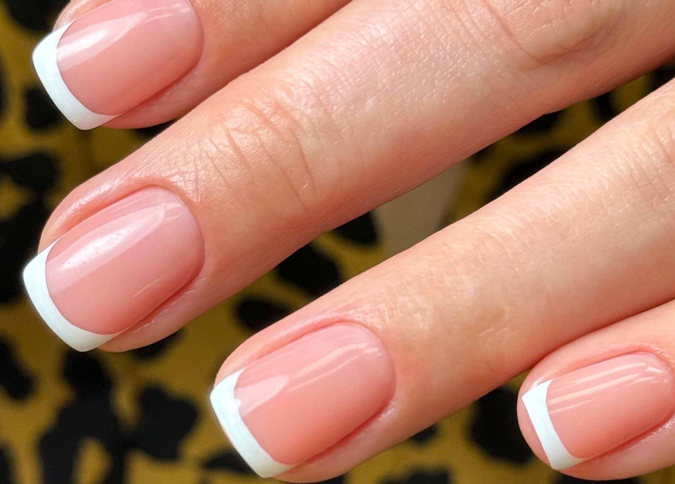 French manicure nails at Chic Nail Studio in Arlington, Virginia, US with sleek white tips and glossy finish.