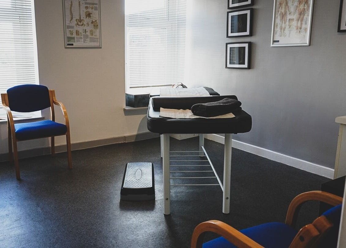 Modern therapy room at Select Therapy, Alexandra Road, Gorseinon, Wales, GB with massage table and chairs.