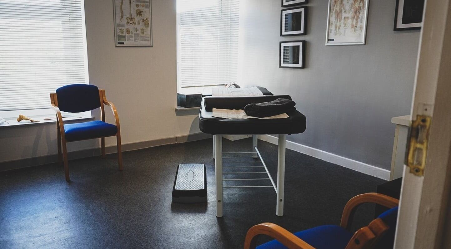 Modern therapy room at Select Therapy, Alexandra Road, Gorseinon, Wales, GB with massage table and chairs.