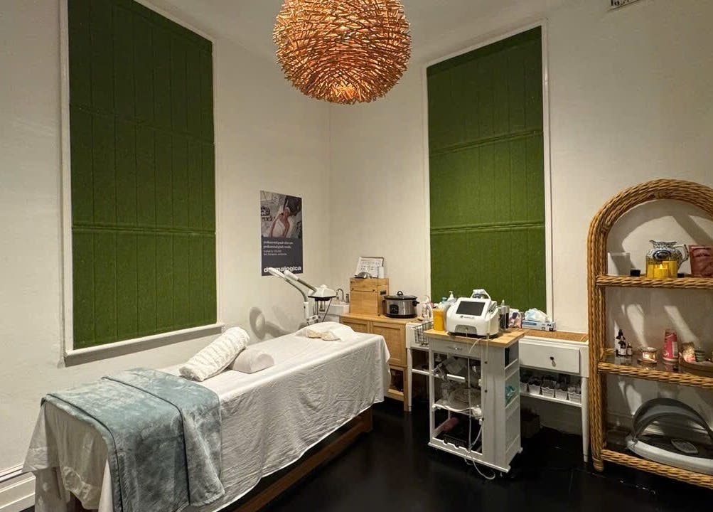 Serene treatment room at Mystic Spa & Wellness, Petersham, New South Wales, AU with massage table and rattan decor.