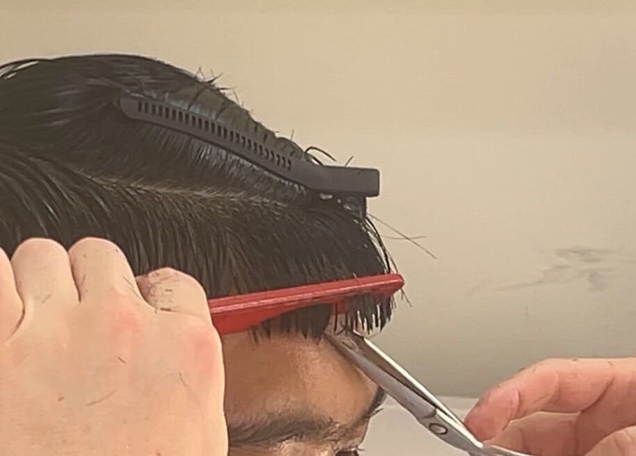 Stylist expertly trims hair at zacW in Killarney Heights, New South Wales, AU.