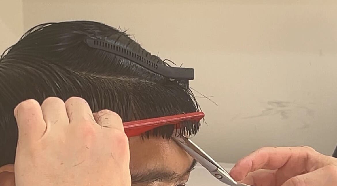 Stylist expertly trims hair at zacW in Killarney Heights, New South Wales, AU.