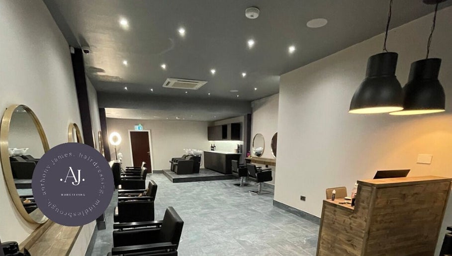 Modern interior of Anthony James Hairdressing in Middlesbrough, England, GB with stylish chairs and lighting.