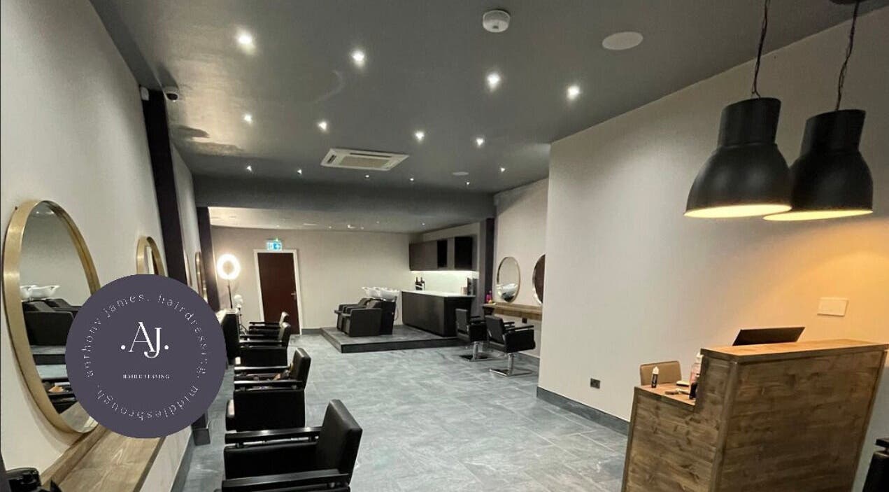 Sophisticated interior of Anthony James Hairdressing, Middlesbrough, England, GB featuring modern styling stations.