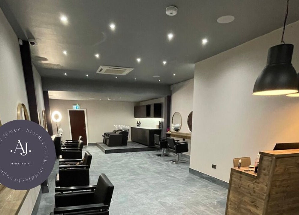 Stylish interior of Anthony James Hairdressing, Middlesbrough, England, GB with modern decor and inviting lighting.
