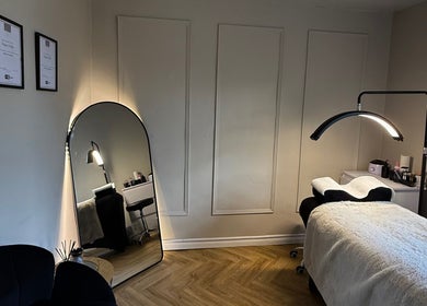 Elegant treatment room at Luxe Beauty, Ripon, England, GB, featuring a plush massage table and ambient lighting.