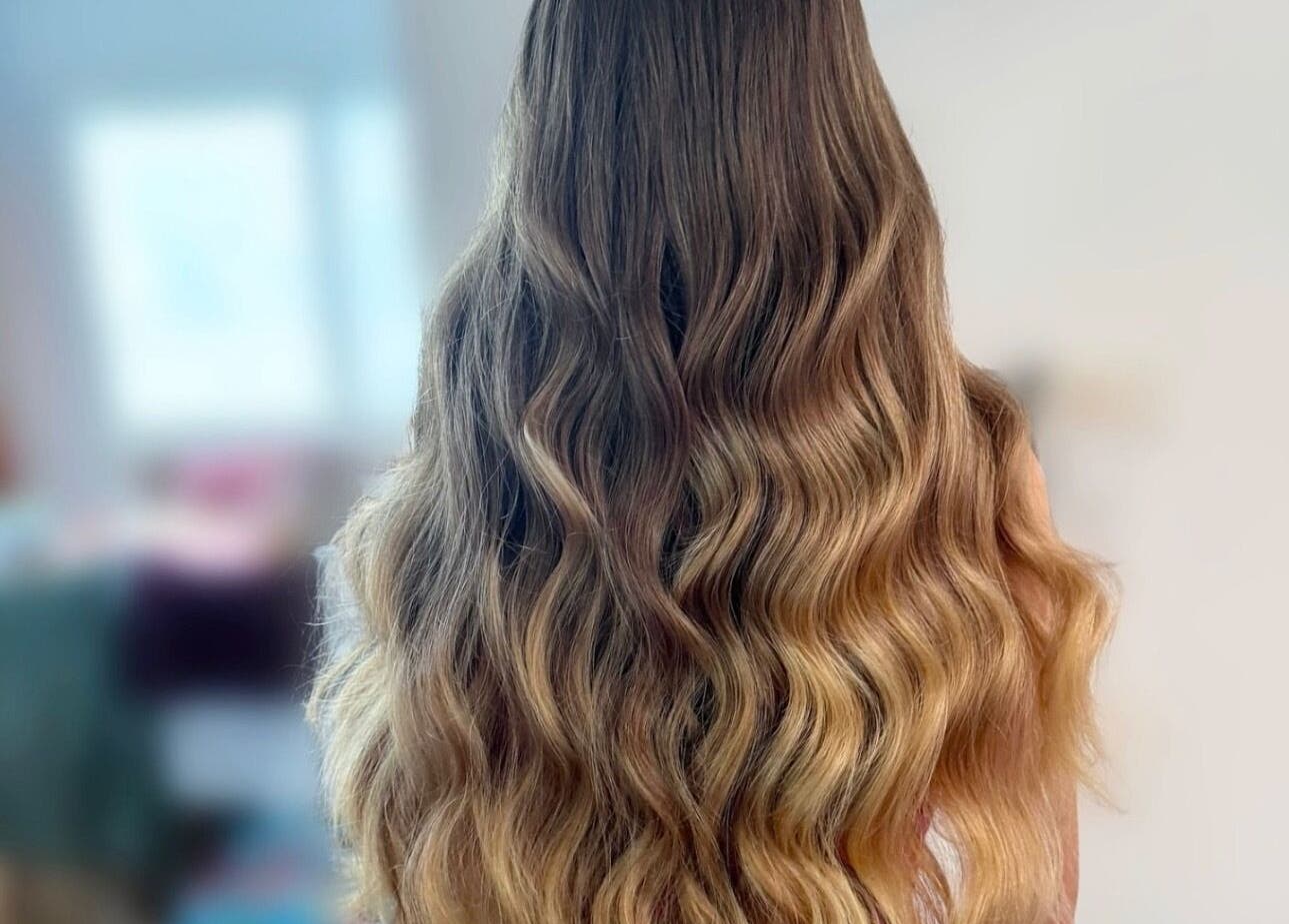 Wavy hairstyle at Glowbykarla Beauty in Bradfield, New South Wales, AU, showcasing vibrant golden hues.