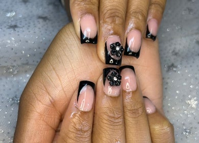 Elegant black French nails with floral design at Touch of Amie, Detroit, Michigan, US.