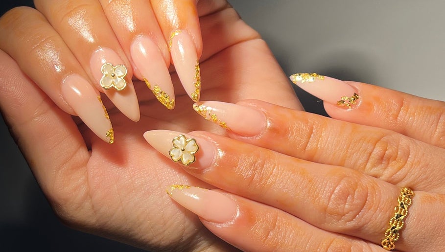 Elegant stiletto nails with gold accents at Touch of Amie, Taylor, Michigan, US.