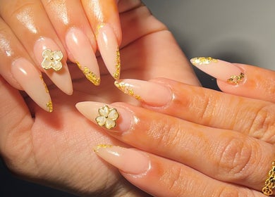 Elegant stiletto nails with gold accents at Touch of Amie, Taylor, Michigan, US.