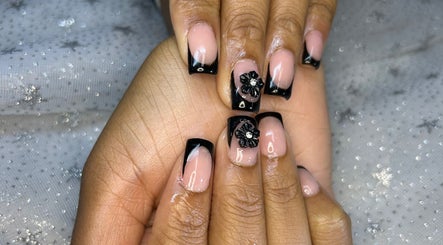 Elegant black and pink nails with floral design at Touch of Amie, Taylor, Michigan, US.