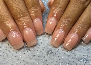 Elegant manicured nails at Touch of Amie in Taylor, Michigan, US, showcasing glossy, natural finish.