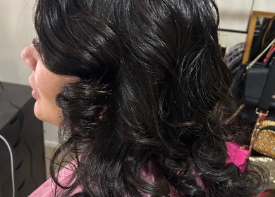 Woman with elegant curls styled at Touch of Amie in Taylor, Michigan, US.