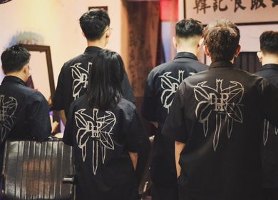 Back view of Sause Barbershop stylists in uniform, George Town, Pulau Pinang, MY.