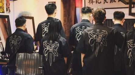 Back view of Sause Barbershop stylists in uniform, George Town, Pulau Pinang, MY.