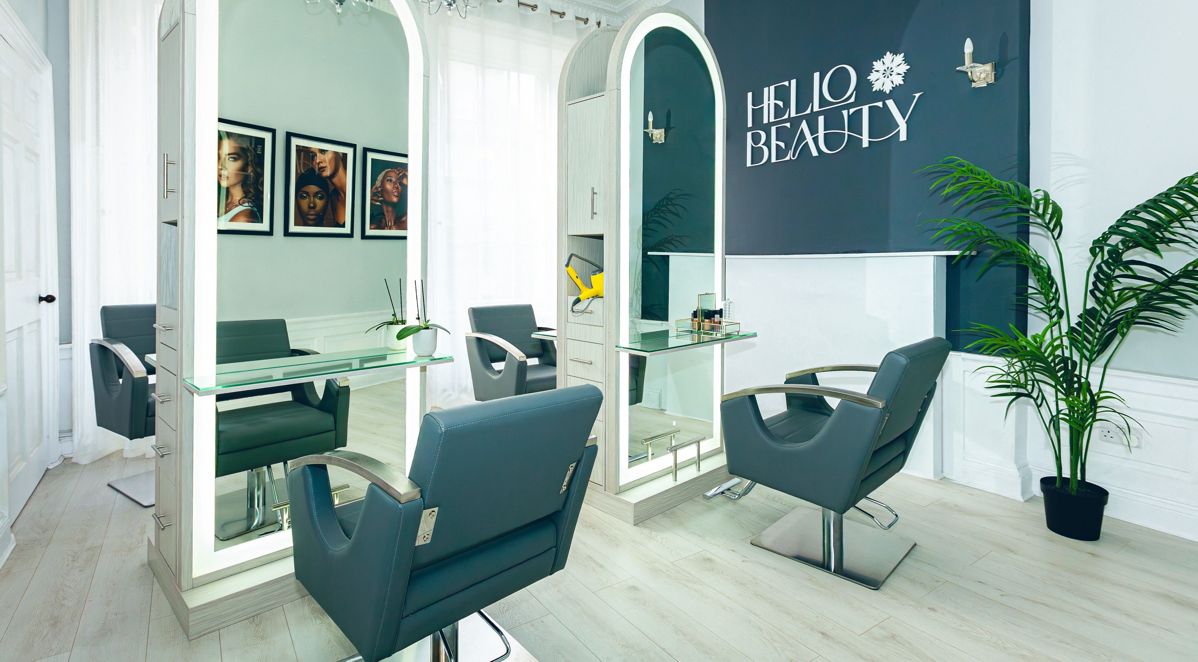 Modern salon interior at Hello Beauty, Edinburgh, Scotland, GB with stylish chairs and large mirrors.
