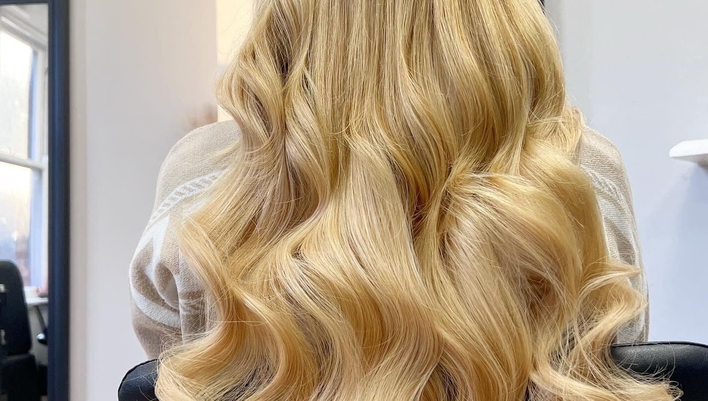 Blonde wavy hair styled at Danielle Extensions, Dublin, County Dublin, IE, showcasing vibrant color and shine.