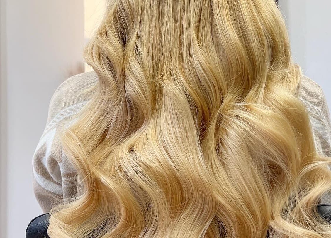 Blonde wavy hair styled at Danielle Extensions, Dublin, County Dublin, IE, showcasing vibrant color and shine.