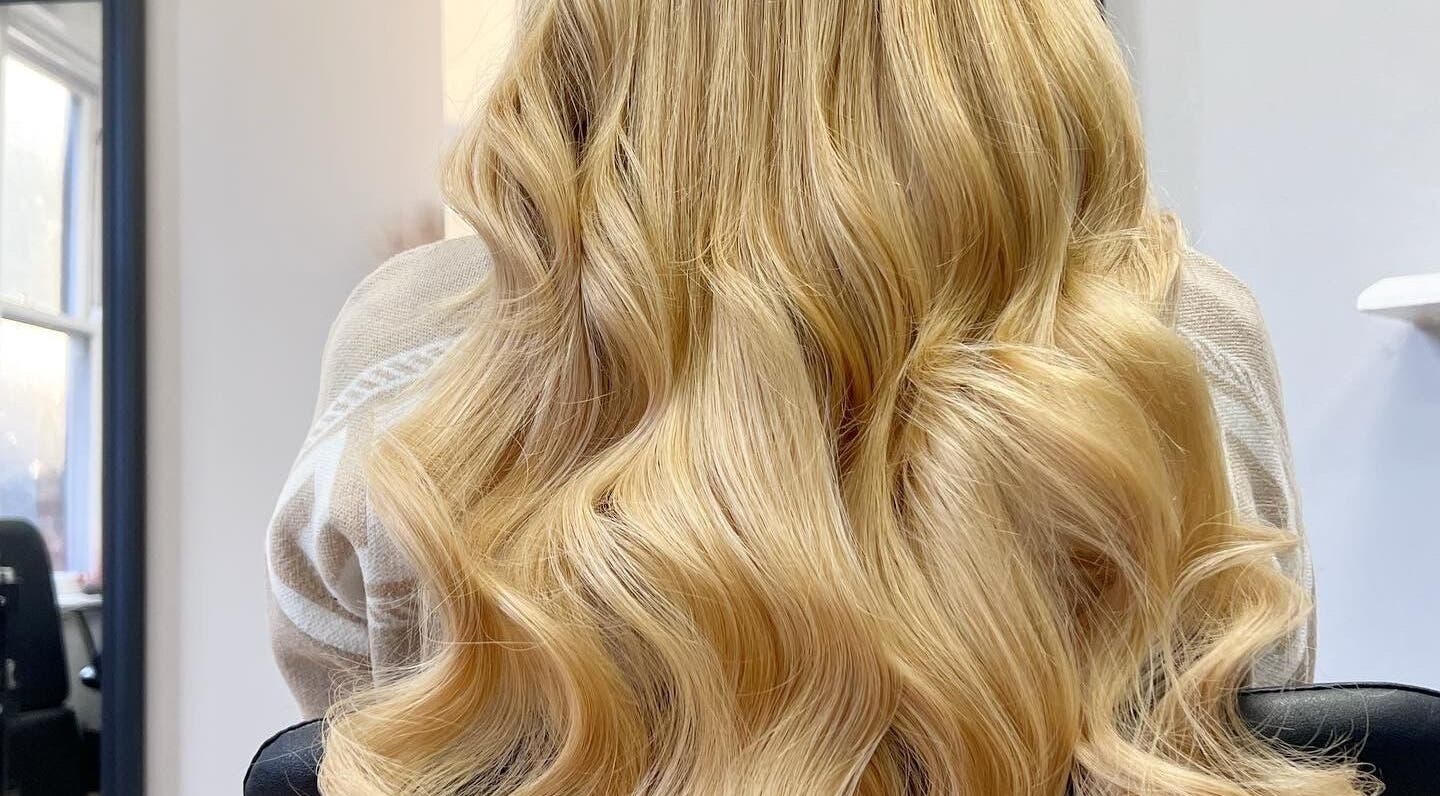 Blonde wavy hair styled at Danielle Extensions, Dublin, County Dublin, IE, showcasing vibrant color and shine.