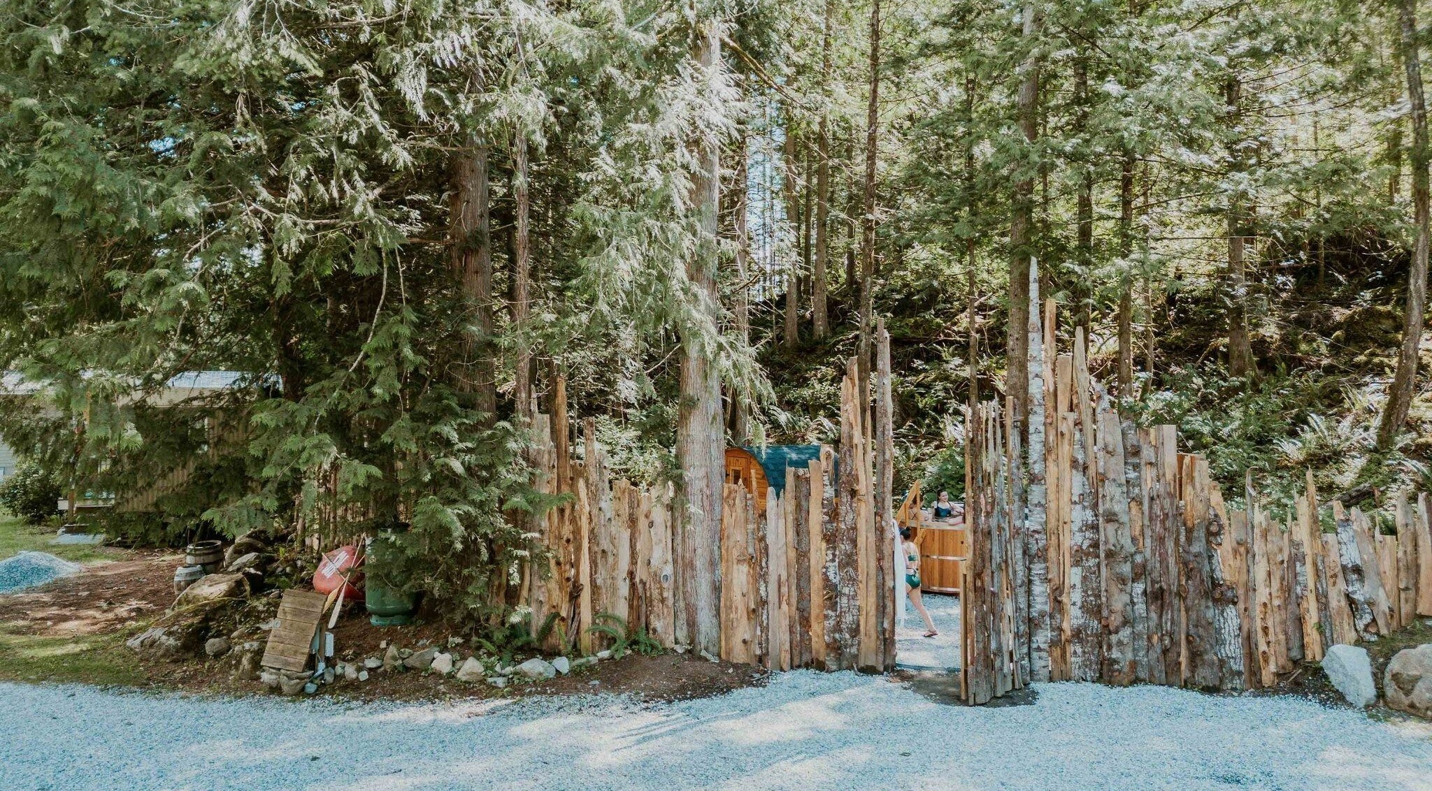 Entrance to The Moonshine Spa surrounded by lush forest in Madeira Park, British Columbia, CA.