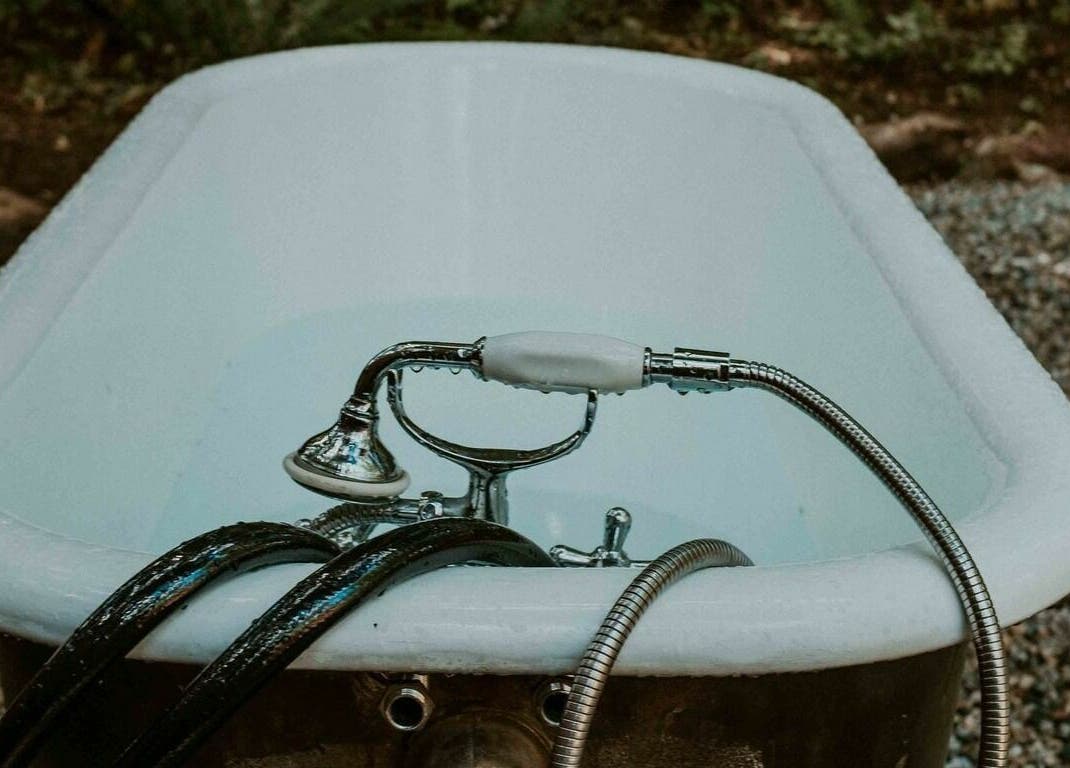 Vintage bathtub in a forest setting at The Moonshine Spa, Madeira Park, British Columbia, CA.