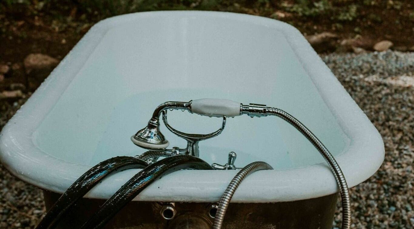 Vintage bathtub in a forest setting at The Moonshine Spa, Madeira Park, British Columbia, CA.