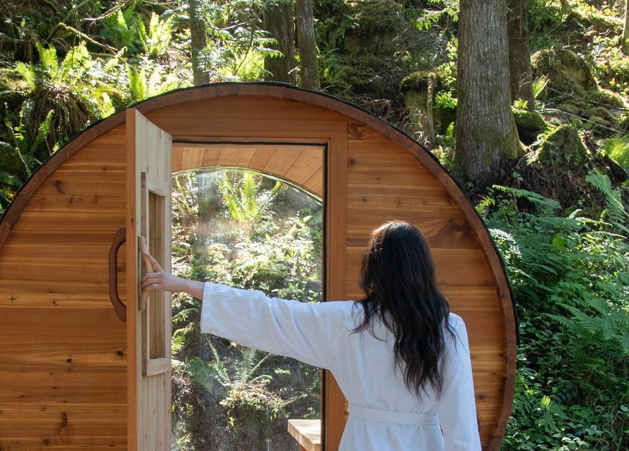 Wooden outdoor sauna at The Moonshine Spa, nestled in a lush forest, Madeira Park, British Columbia, CA.
