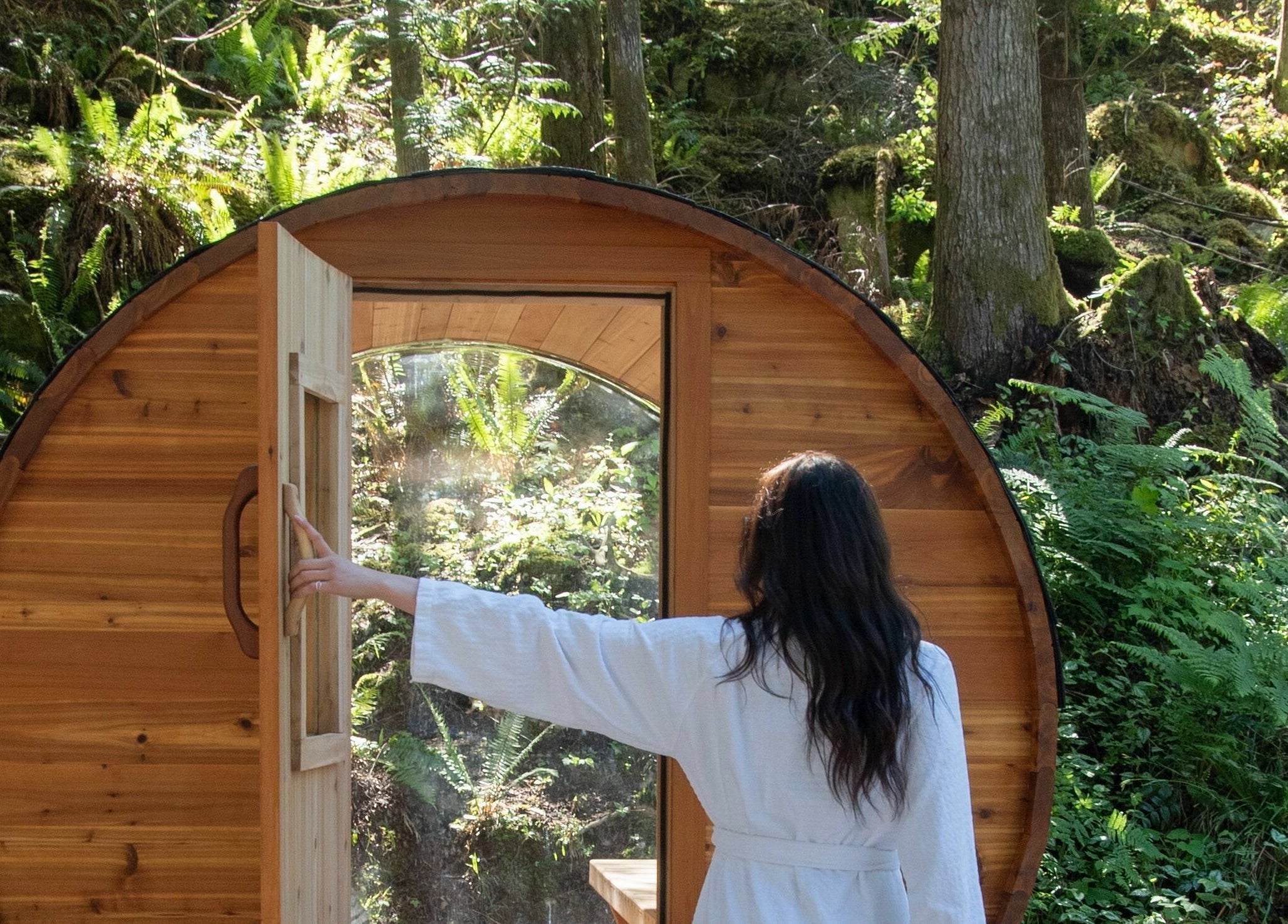 Wooden outdoor sauna at The Moonshine Spa, nestled in a lush forest, Madeira Park, British Columbia, CA.