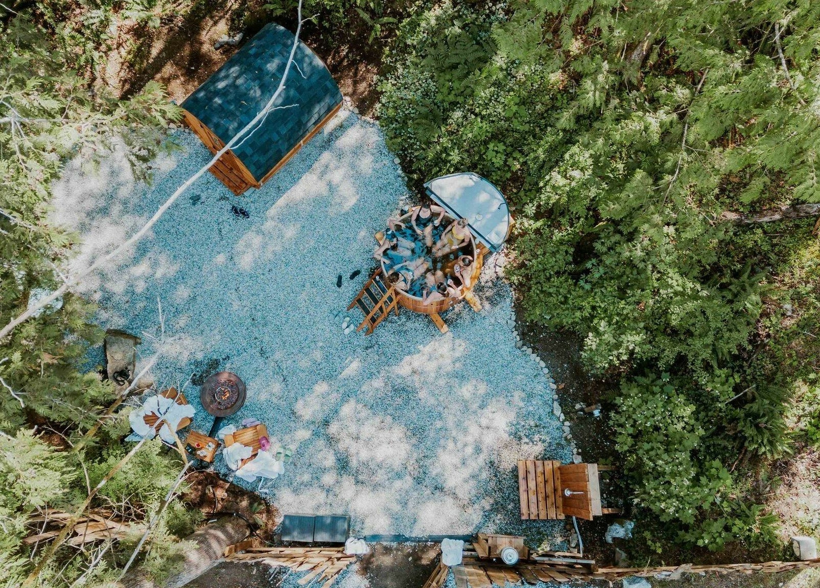 Aerial view of outdoor relaxation area at The Moonshine Spa, Madeira Park, BC, CA surrounded by lush greenery.