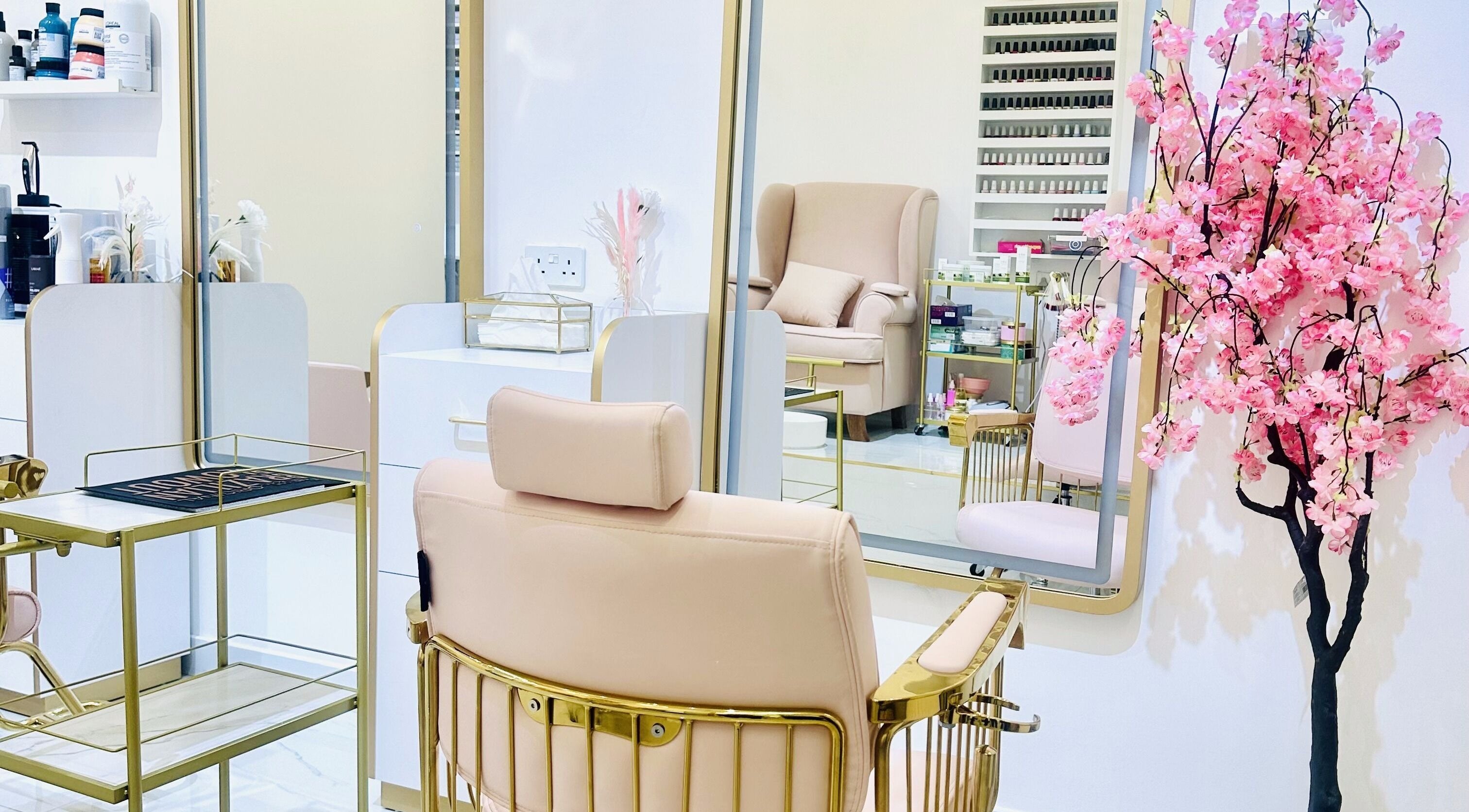 Elegant interior of De Bliss Beauty Lounge in Dubai, دبي, AE with plush chairs and delicate cherry blossom decor.