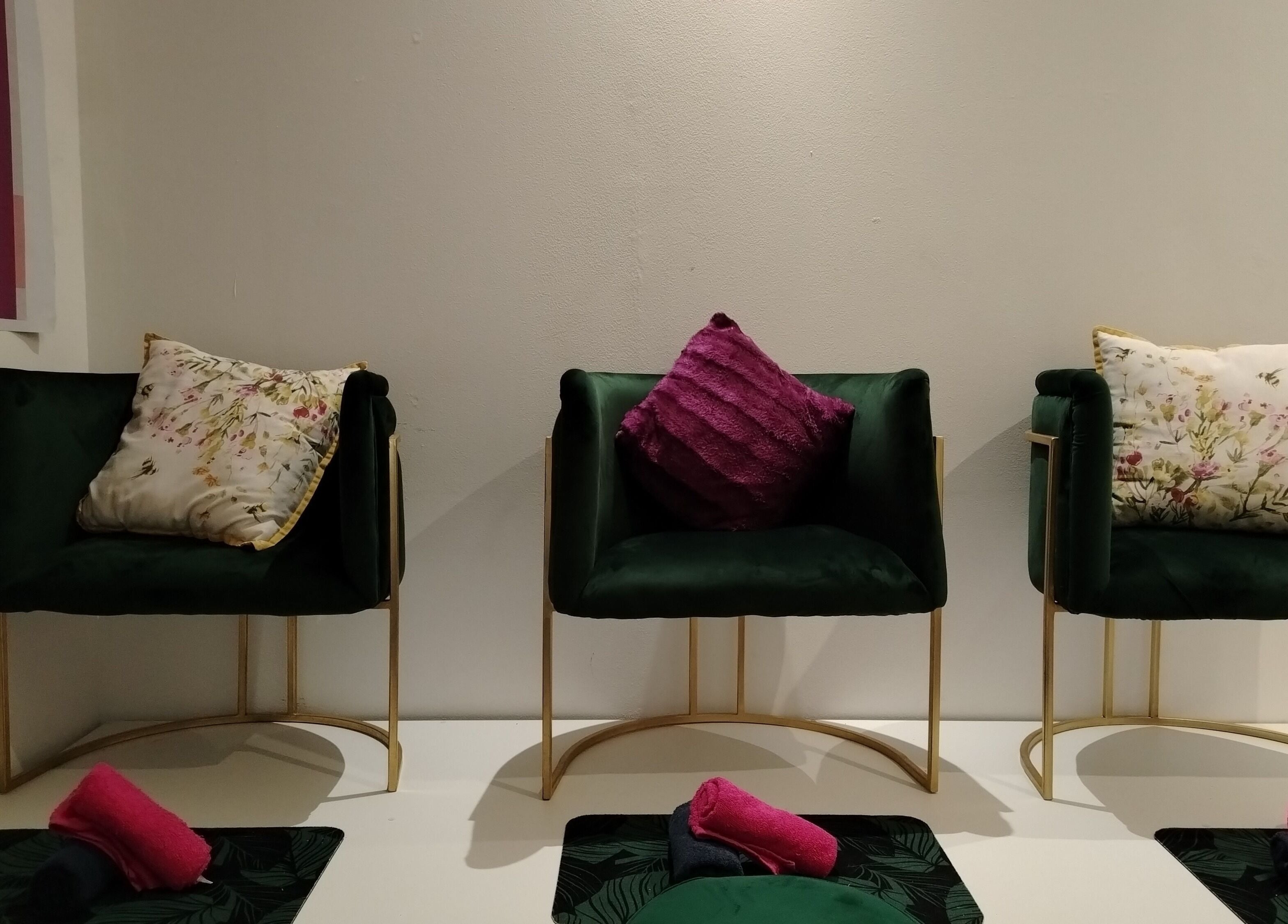 Elegant seating area at La Vita E Bella Spa in Johannesburg, Gauteng, ZA with plush chairs and floral cushions.