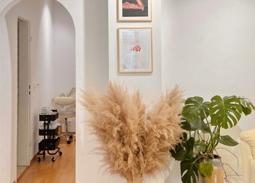 Elegant interior of Torico of Beauty in Basel, Basel-stadt, CH showcasing a cozy, modern decor with plants and comfy seating.