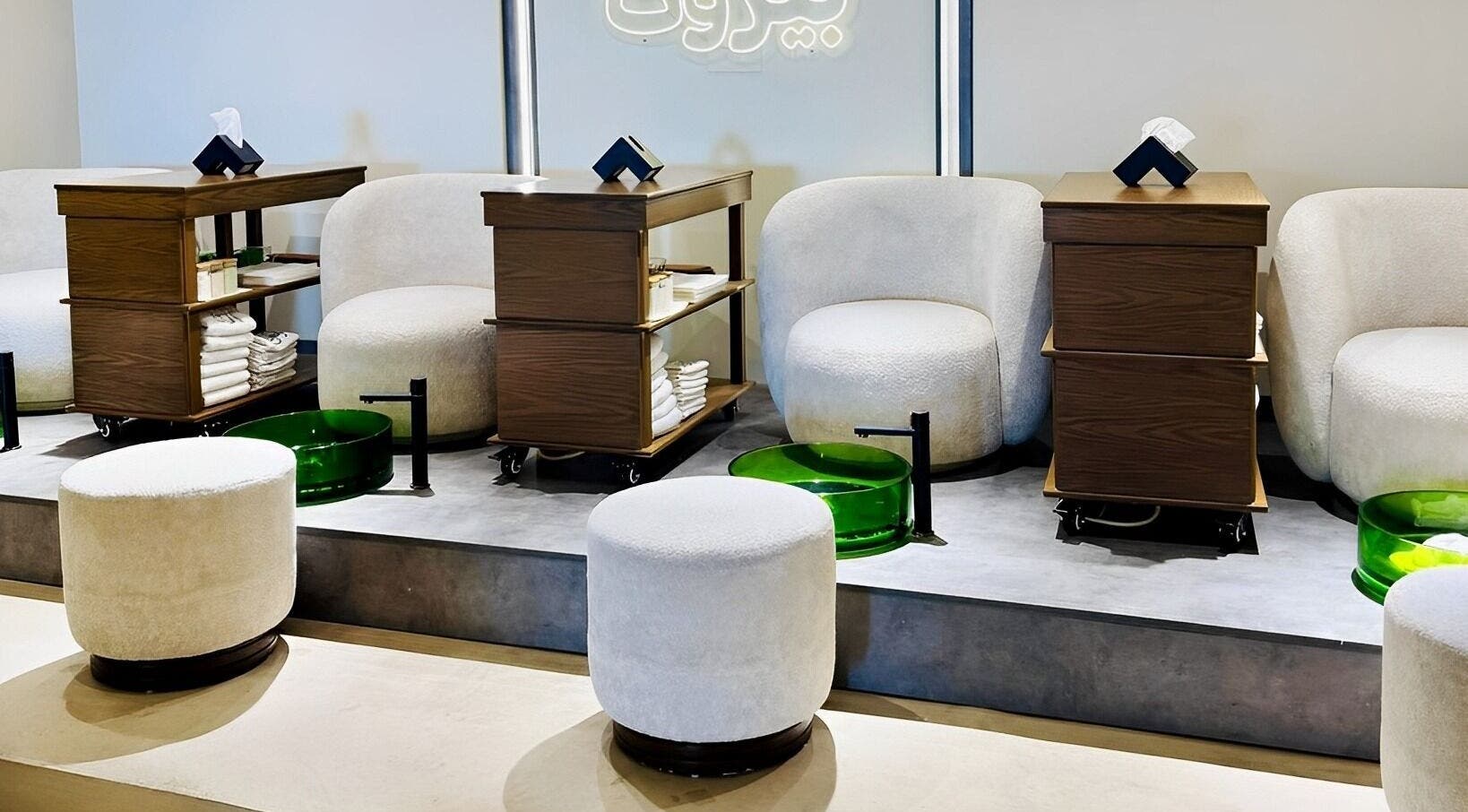 Elegant pedicure stations at Beirut Spa in Beirut, Beirut Governorate, LB with plush seating and green bowls.