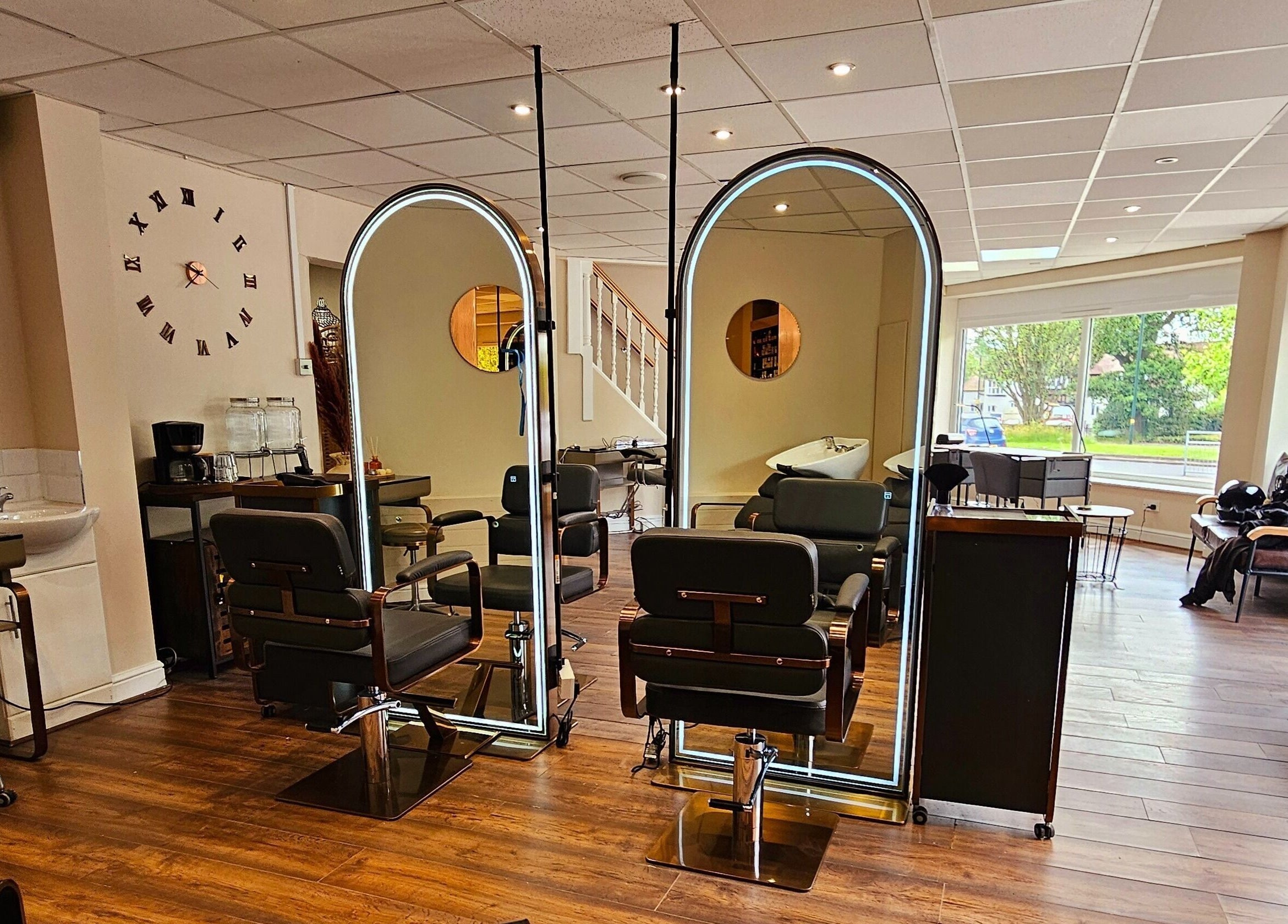 Elegant salon at Ritual Retreat, Birmingham, England, GB, featuring stylish chairs and bright mirrors.