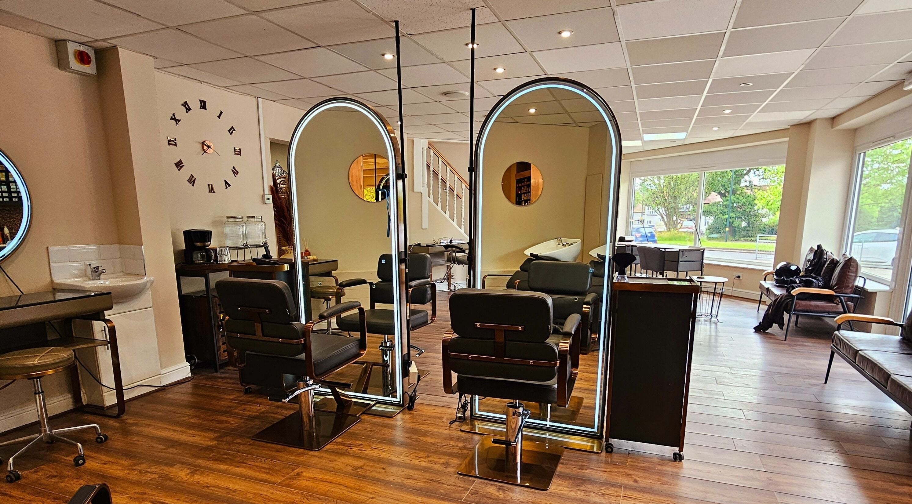Elegant salon at Ritual Retreat, Birmingham, England, GB, featuring stylish chairs and bright mirrors.