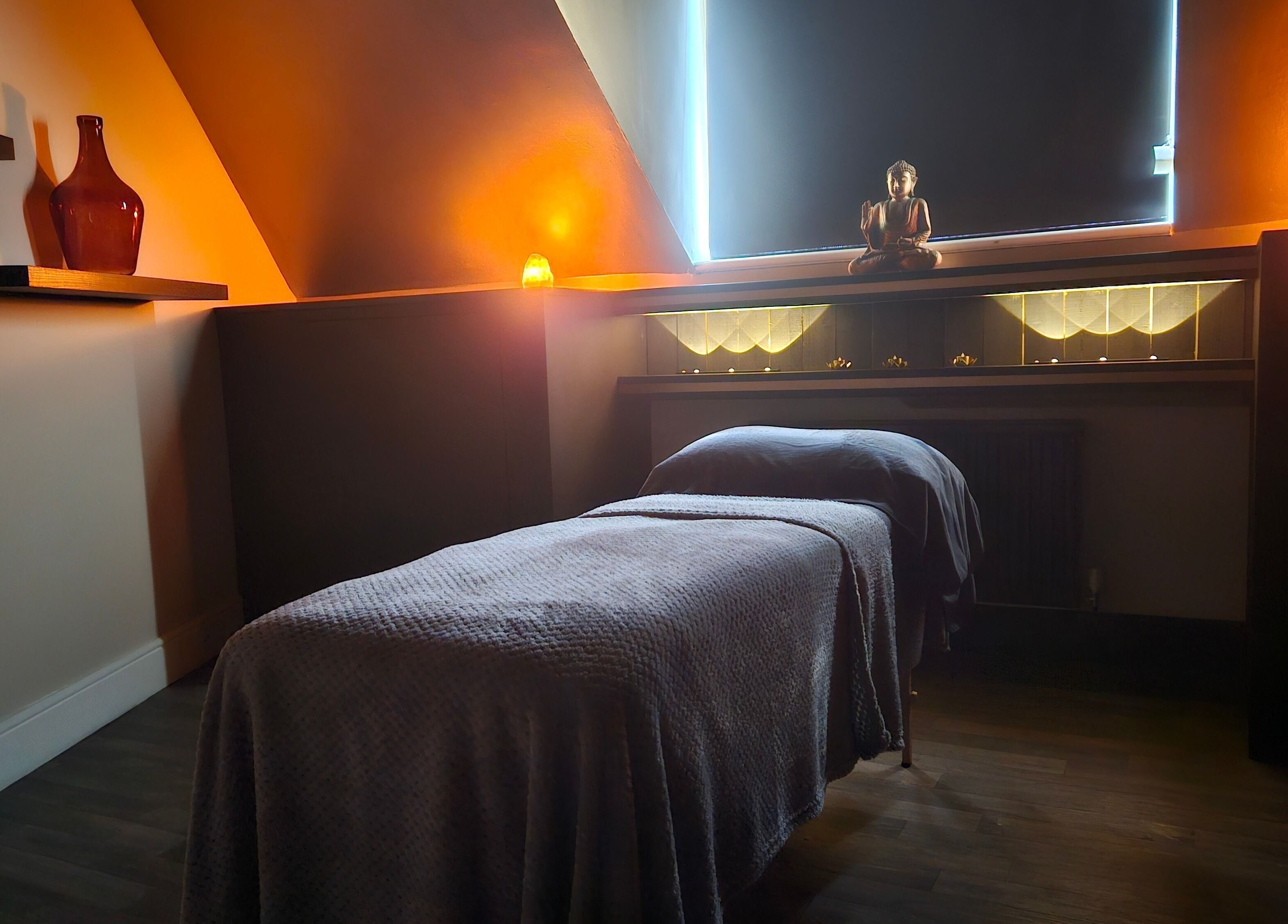 Tranquil massage room at Ritual Retreat, Birmingham, England, GB, with soft lighting and a comfortable massage table.