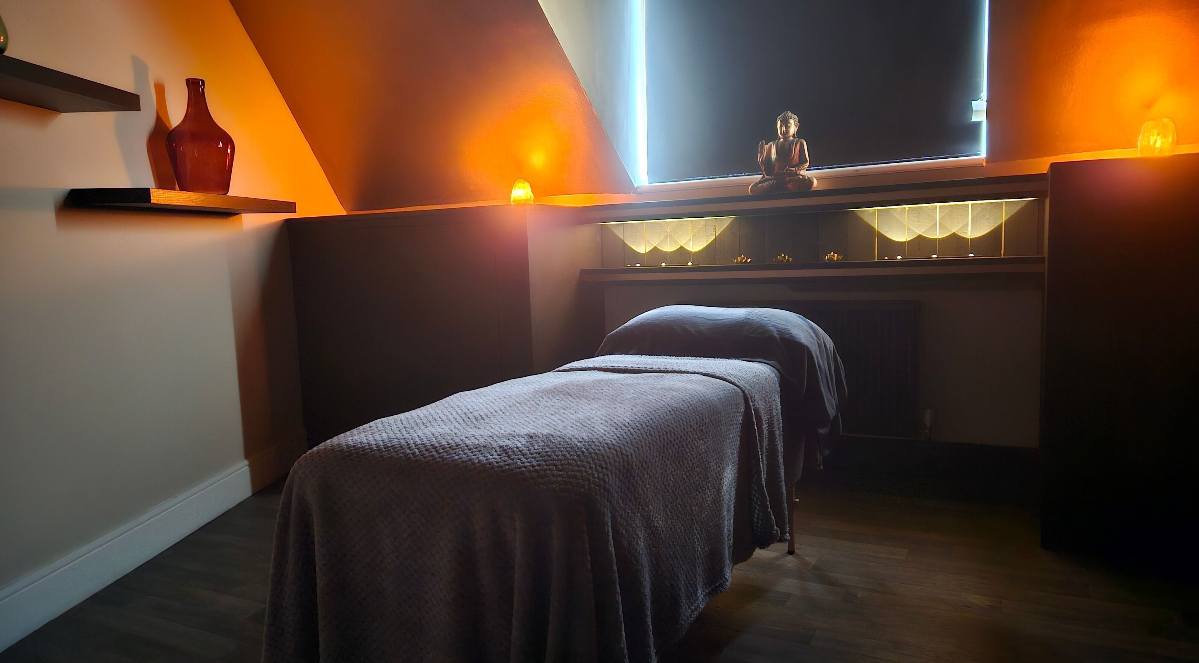 Tranquil massage room at Ritual Retreat, Birmingham, England, GB, with soft lighting and a comfortable massage table.