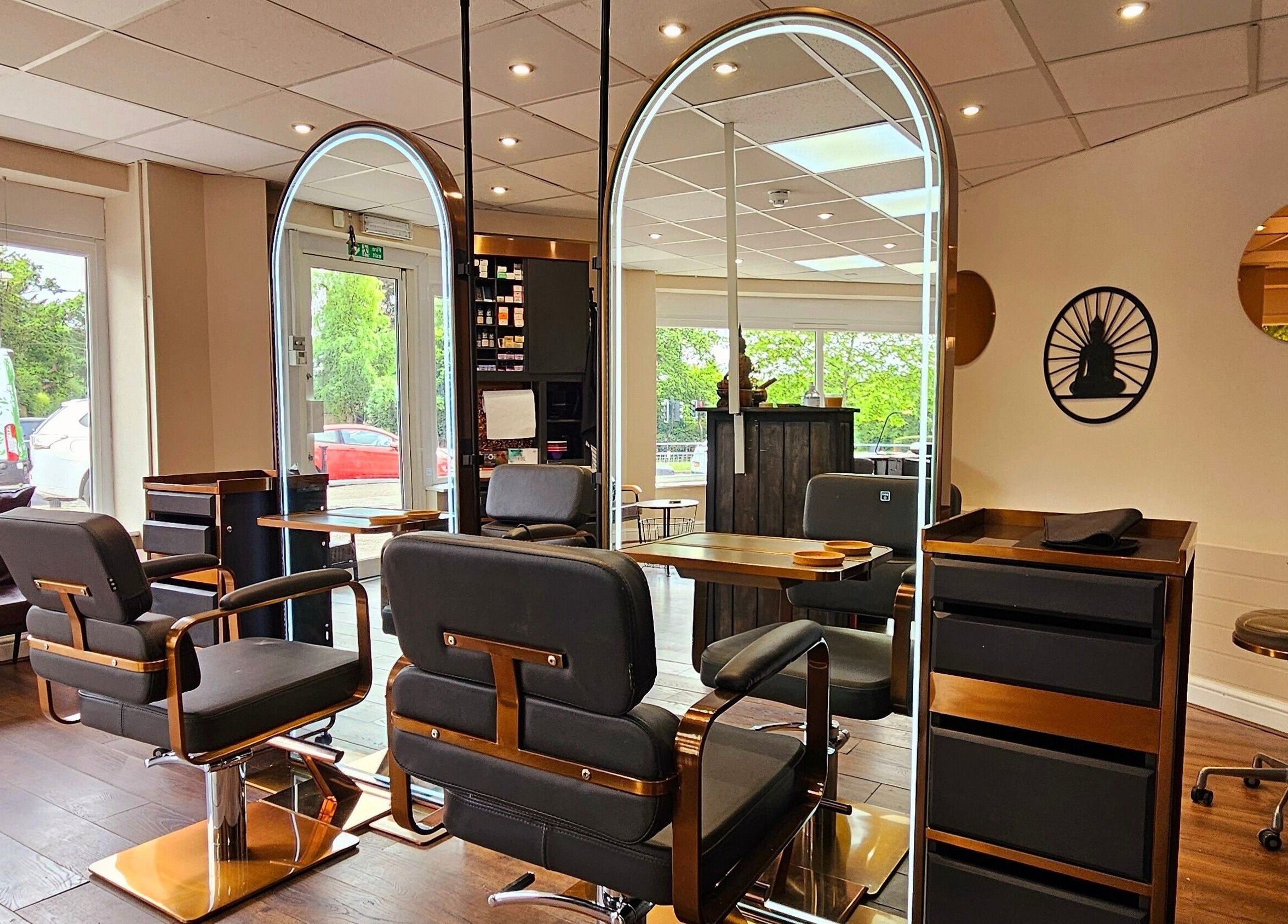 Modern salon interior at Ritual Retreat, Birmingham, England, GB, featuring stylish mirrors and comfortable chairs.