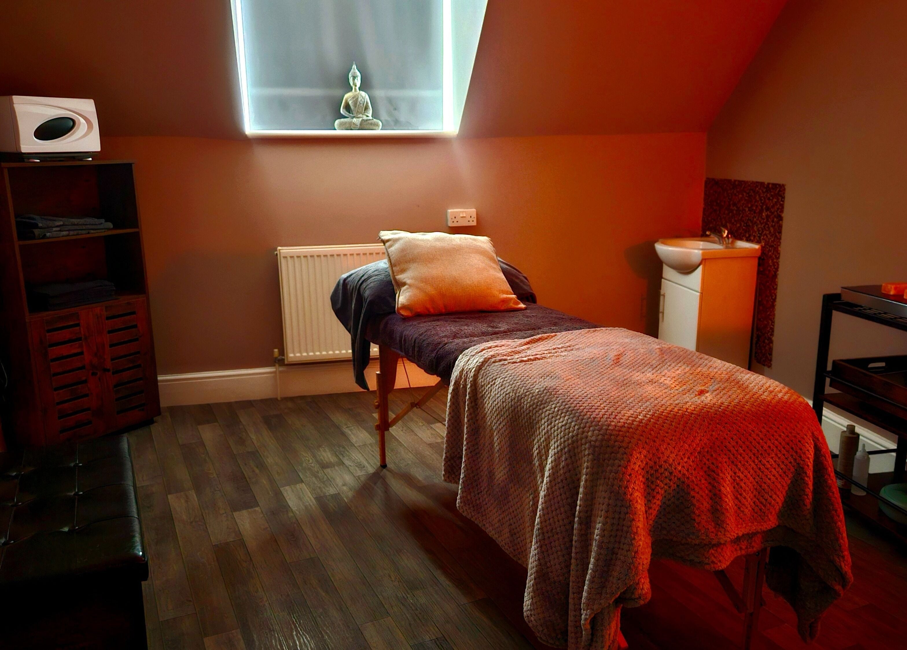 Tranquil massage room at Ritual Retreat, Birmingham, England, GB, featuring warm lighting and peaceful decor.
