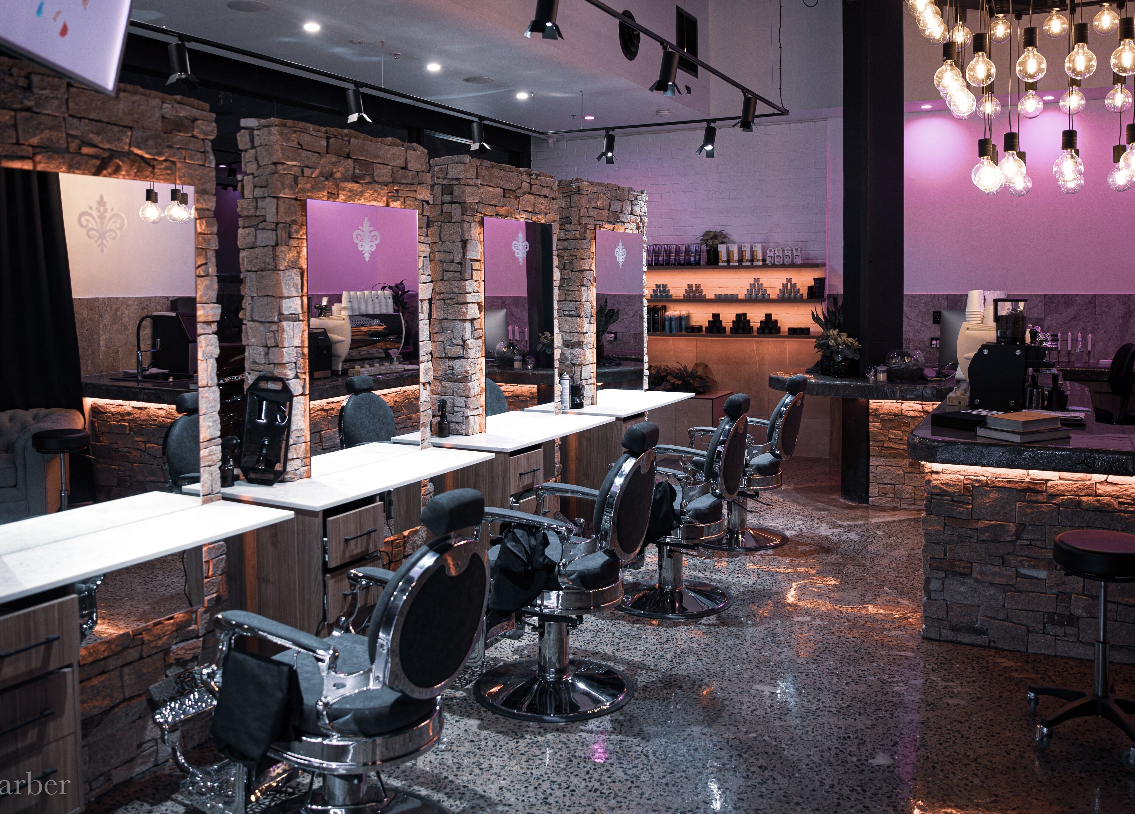 Stylish interior of Langanis Studio in Teneriffe, Queensland, AU, showcasing modern salon chairs and elegant lighting.