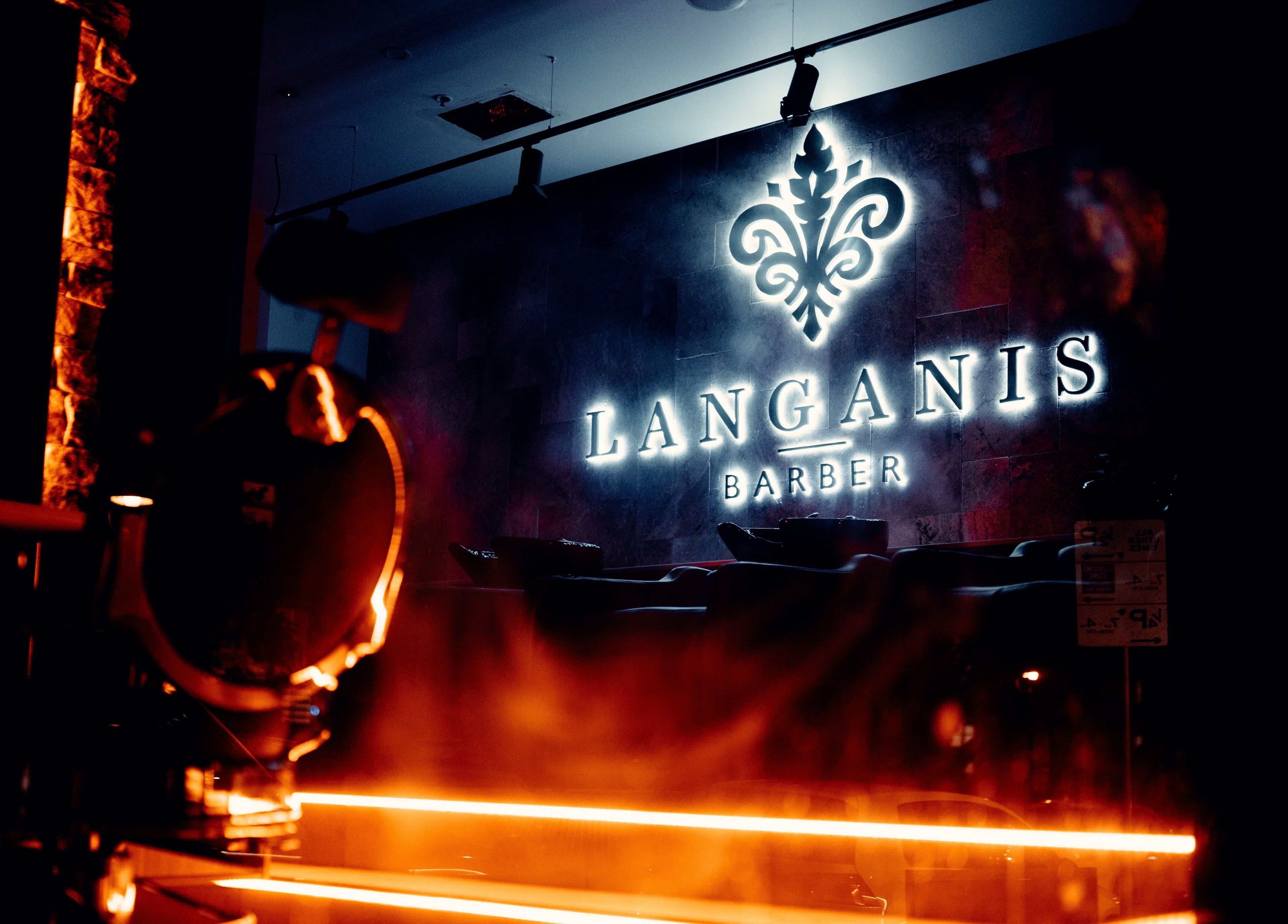 Langanis Studio sign glowing at night, Teneriffe, Queensland, AU. Modern and elegant barbershop ambiance.