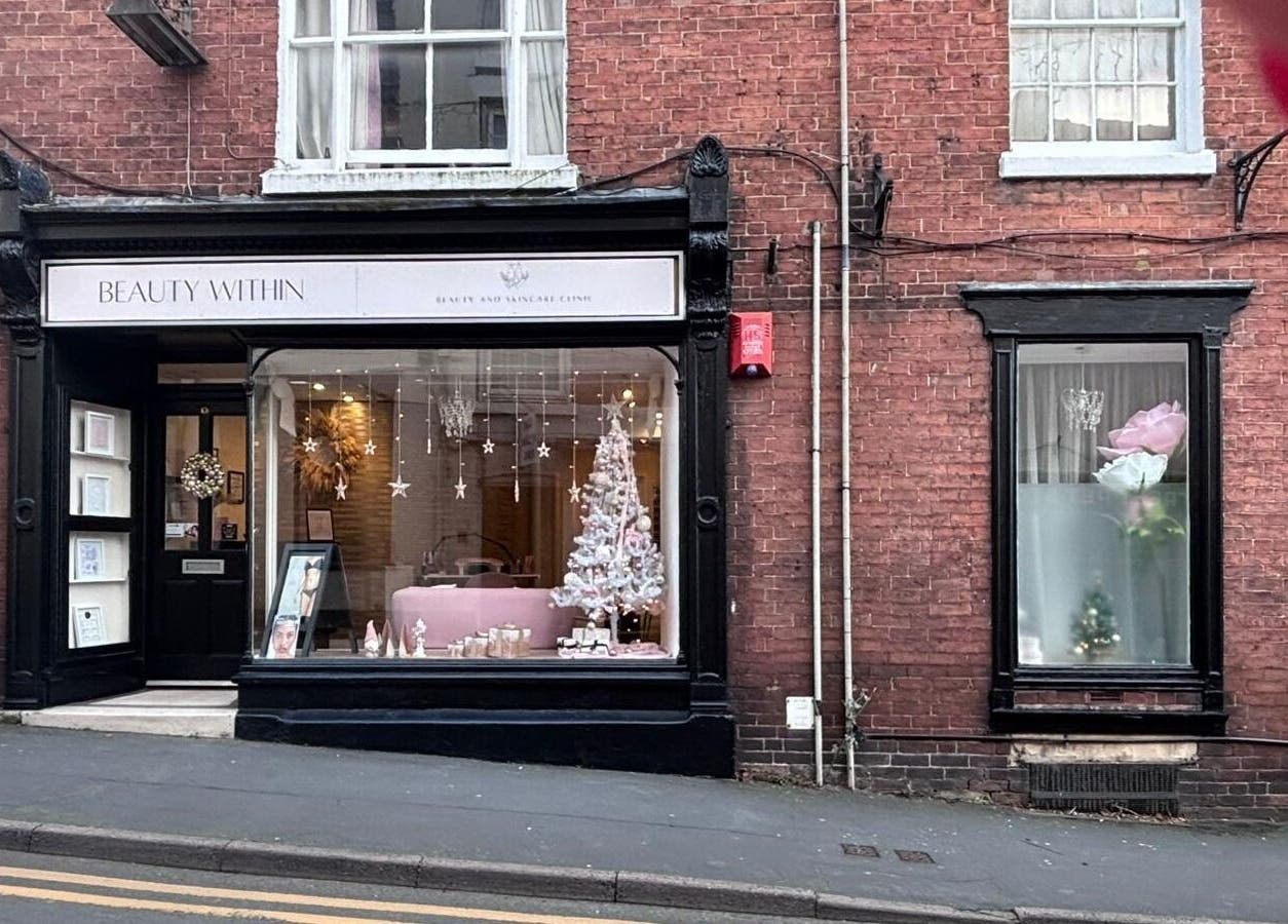 The Pamper Room in Cheadle, England, GB showcases a festive window display with elegant décor.