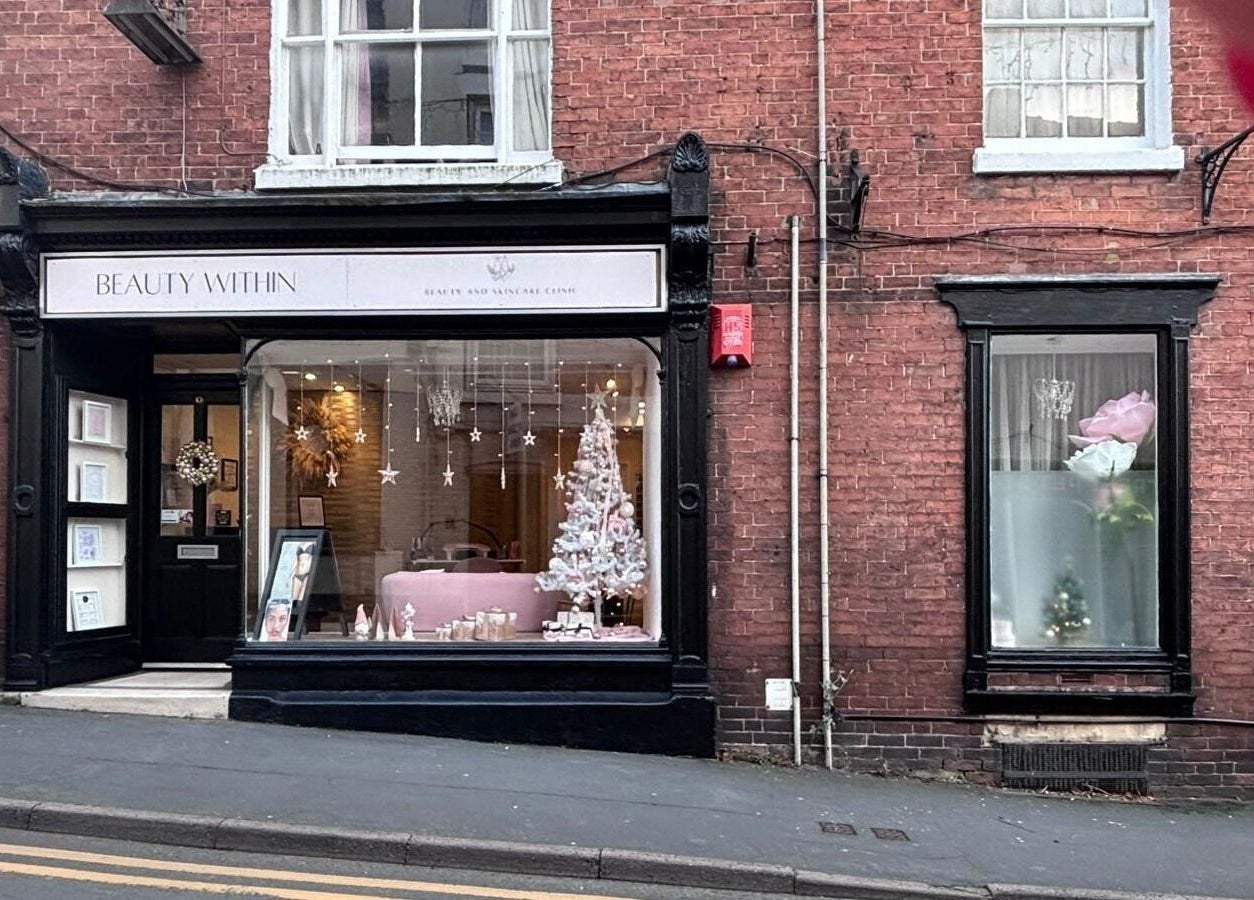 The Pamper Room in Cheadle, England, GB showcases a festive window display with elegant décor.