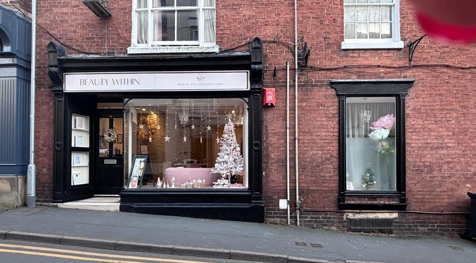 The Pamper Room in Cheadle, England, GB showcases a festive window display with elegant décor.