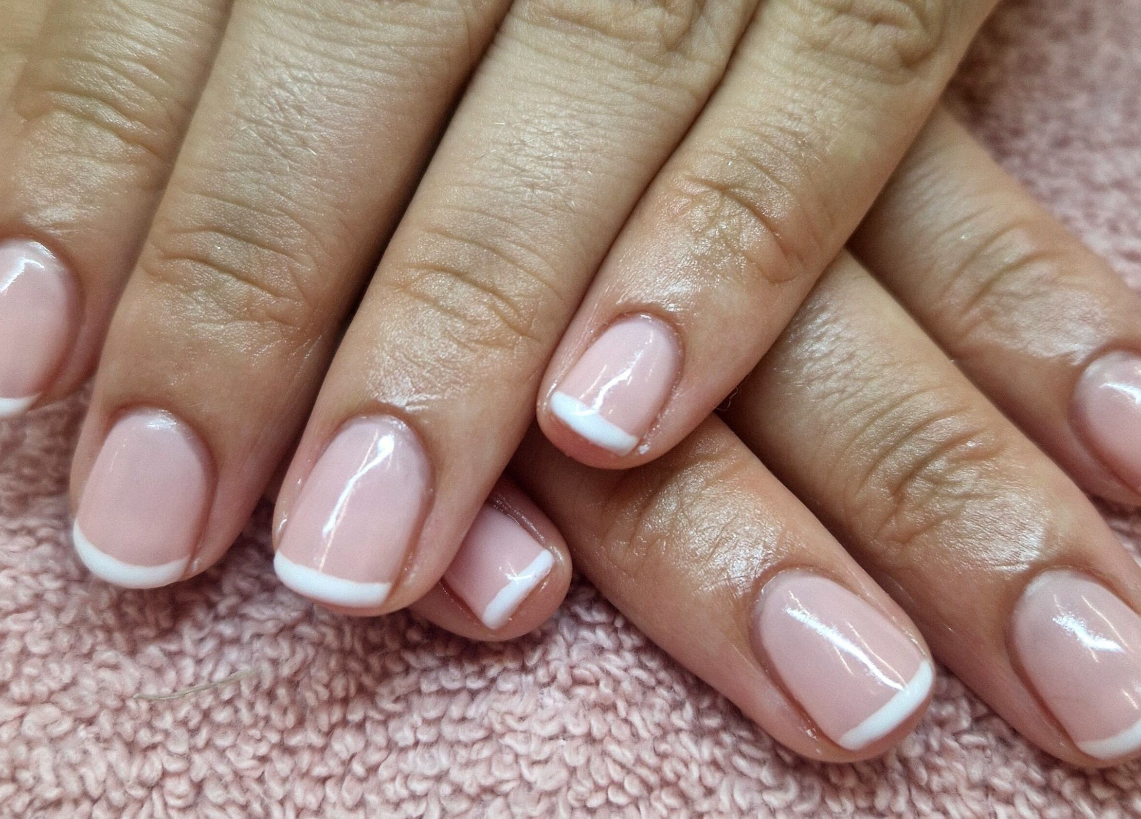 Fresh French manicure at The Pamper Room in Cheadle, England, GB, showcasing glossy, polished nails.