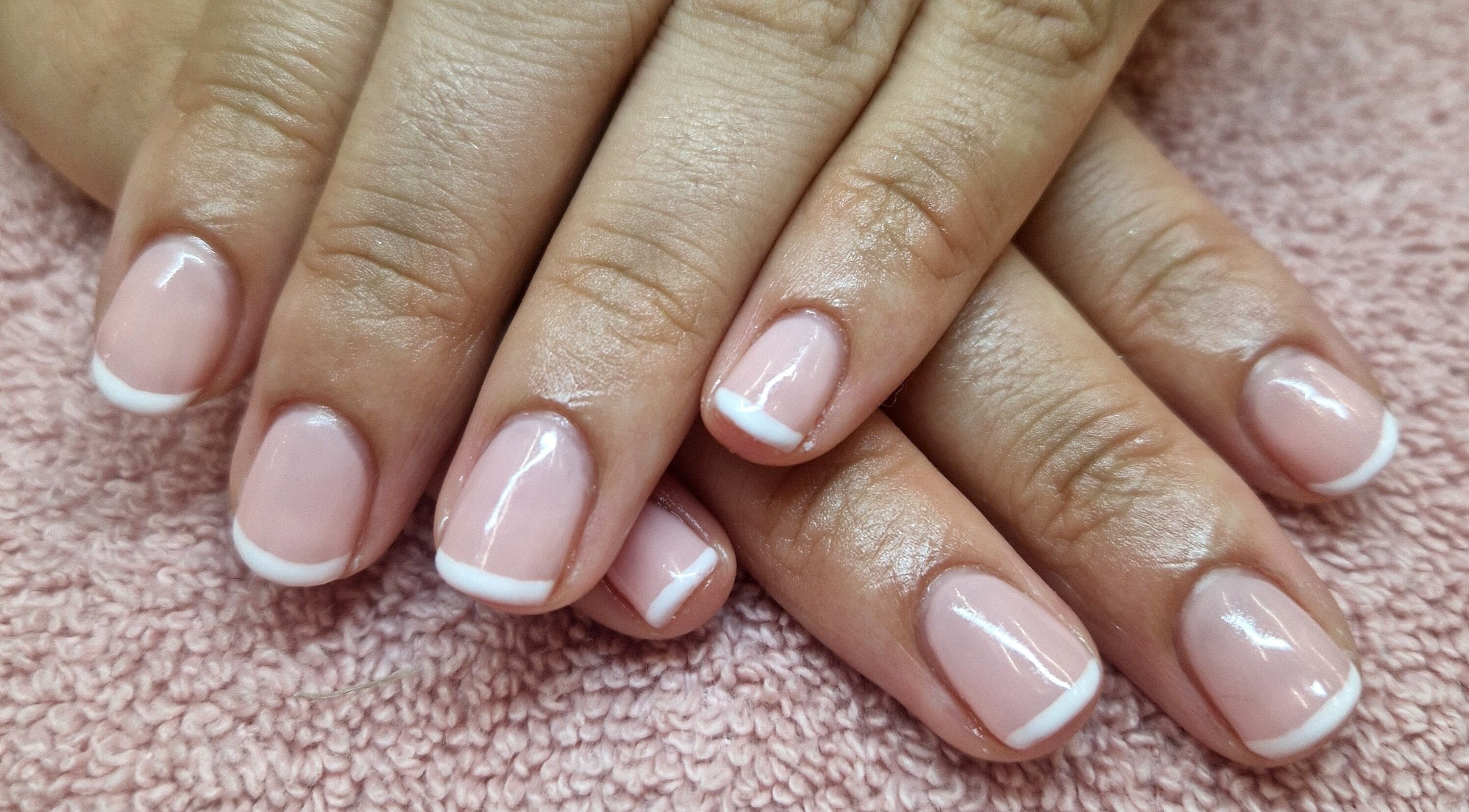 Fresh French manicure at The Pamper Room in Cheadle, England, GB, showcasing glossy, polished nails.