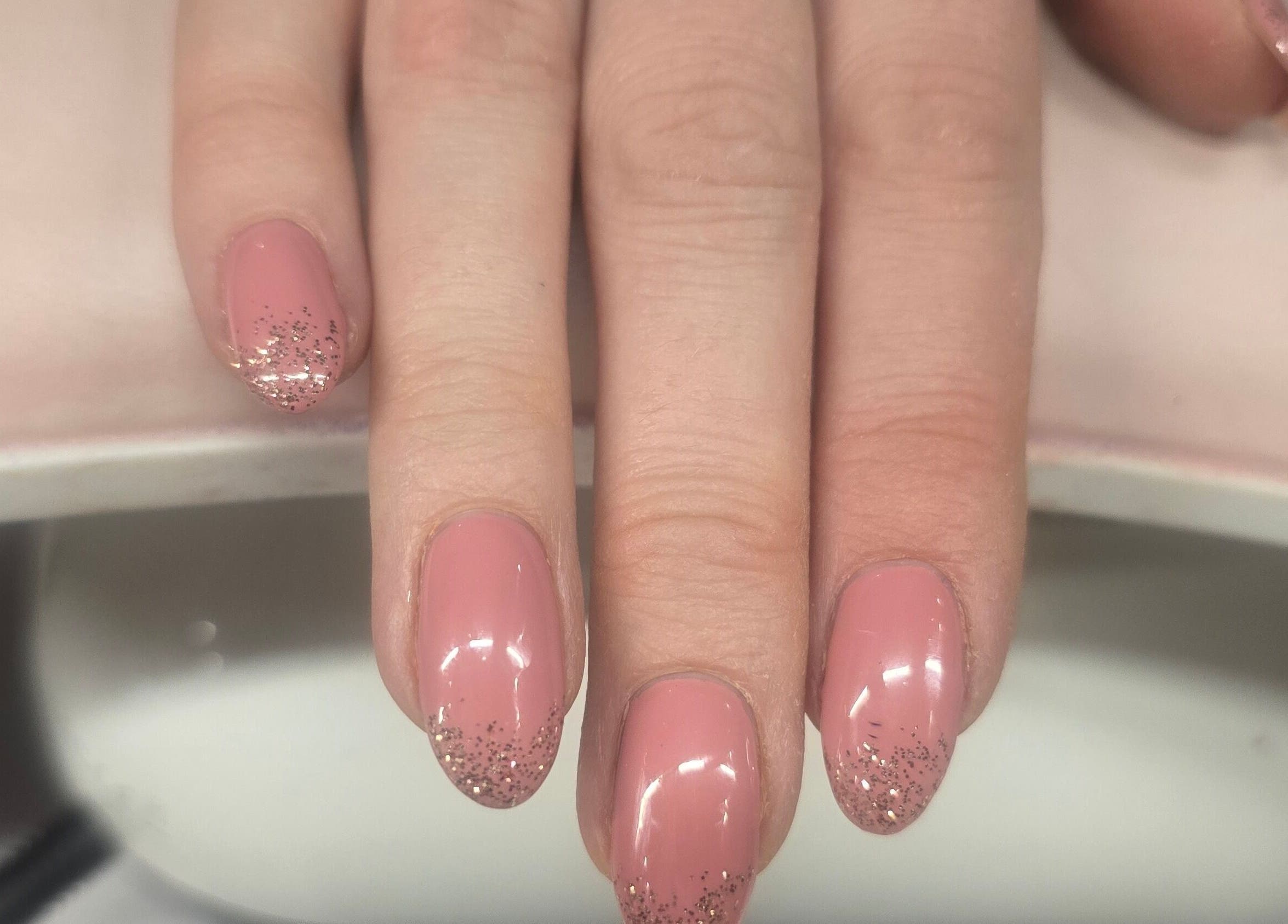 Pink nails with glitter accents at The Pamper Room, Cheadle, England, GB.