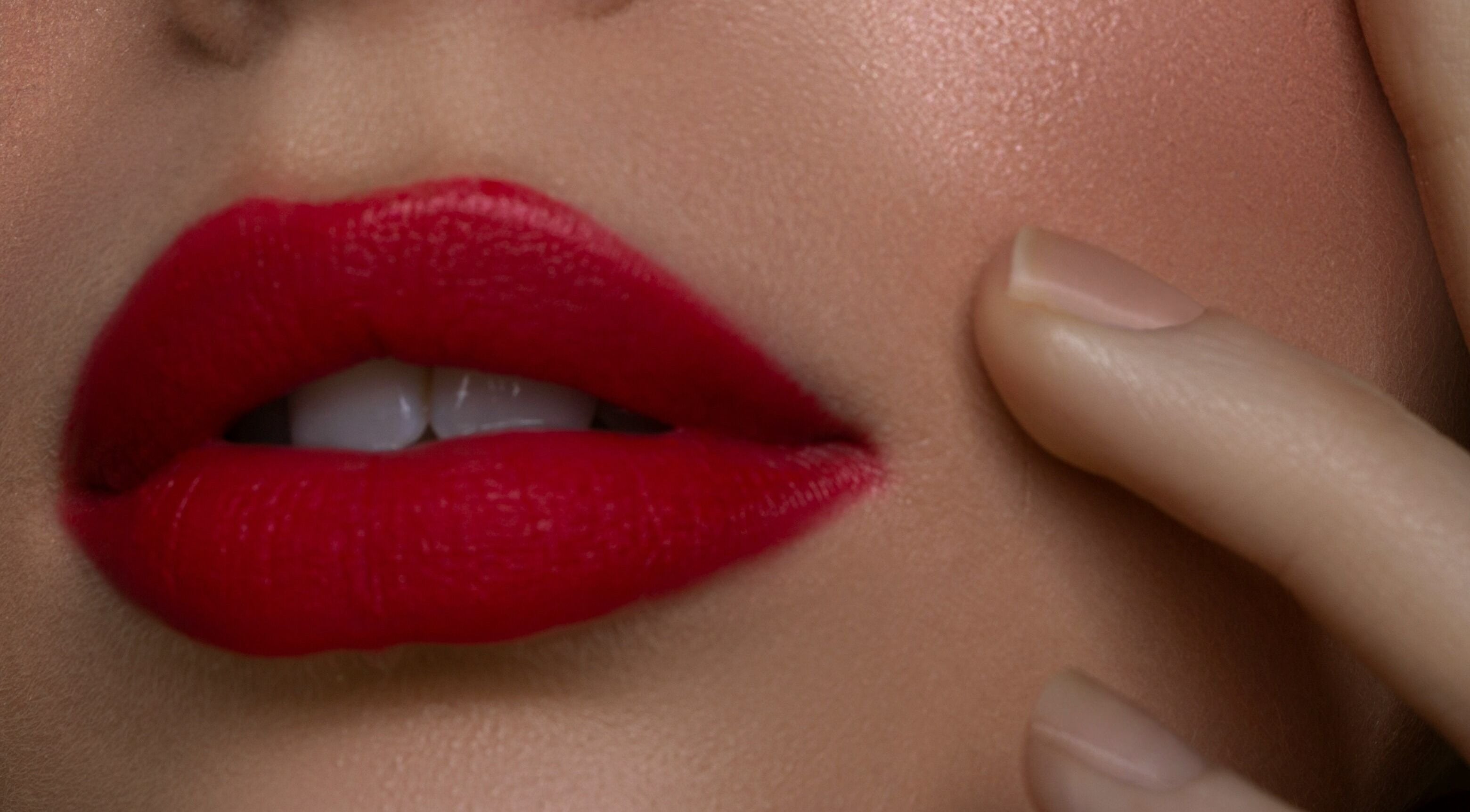 Close-up of vibrant red lips and smooth skin at Ello Beaute in North Richland Hills, Texas, US.