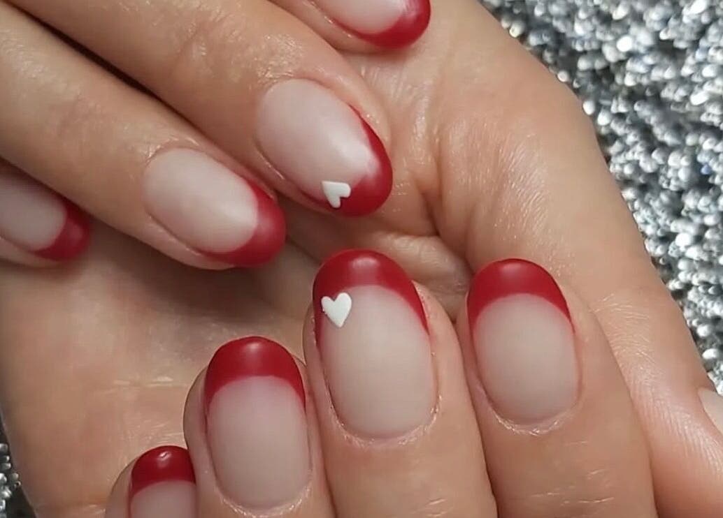 Red French manicure with white hearts at Hands & Heals by Tanya, Hamilton, Ontario, CA.